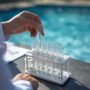 lucid origin_Close up_of_a_technician_s_hands_testing_pool_water_pH_levels_with_a_clear_glass 0 90x90